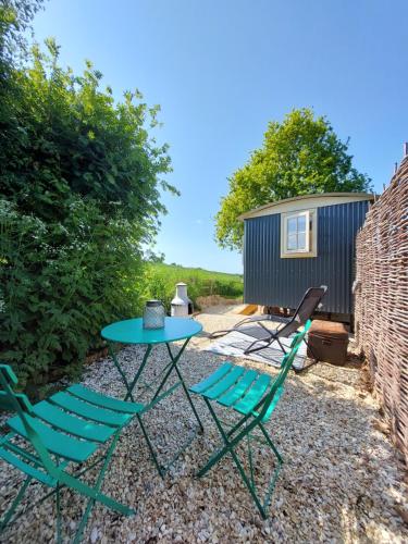a table and two chairs and a tiny house at The Humble Hut in Wooler