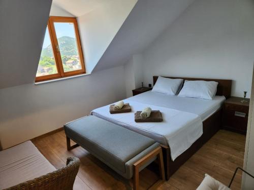 a bedroom with a bed with two towels on it at Dodoši Ksenija in Cetinje