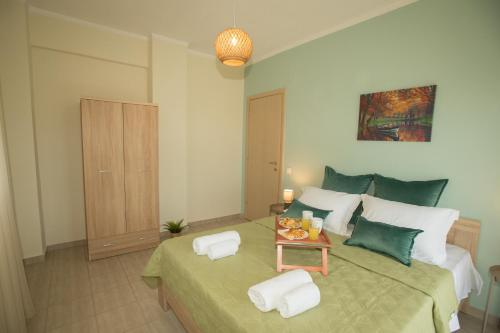 a bedroom with a large bed with a table at Potamos Luxury Apartment in Epanomi