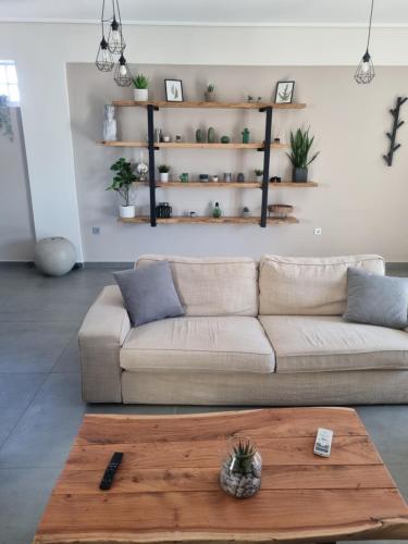 a living room with a couch and a coffee table at New minimal apartment,10' from Athens airport in Spáta