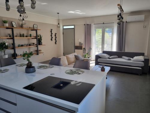 a living room with a couch and a table at New minimal apartment,10' from Athens airport in Spata