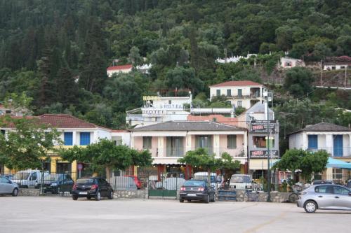 a town with cars parked in a parking lot at Melissani hotel in Sami