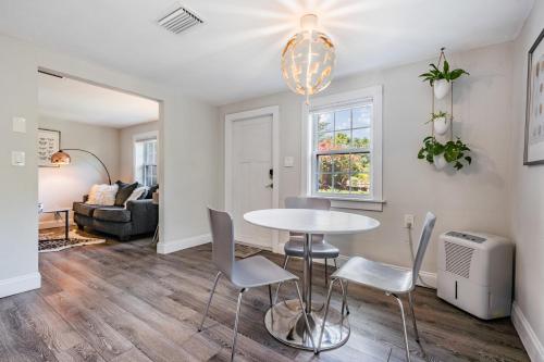 a dining room and living room with a table and chairs at The Urban Nest in Tampa