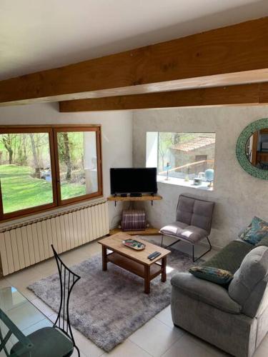a living room with a couch and a coffee table at Chez Camille aux Sieges in Les Rives