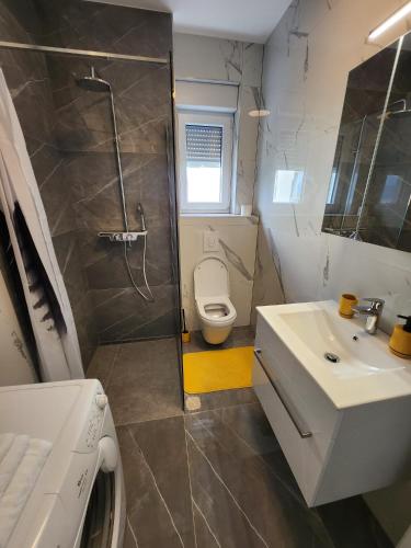 a bathroom with a toilet and a sink and a shower at Feel Good View in Trogir