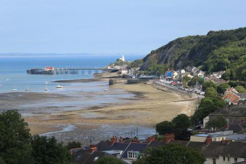 a view of a beach with boats in the water at The Lodge Annex - immaculate coastal property in Oystermouth