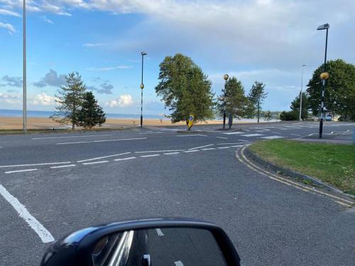 a view of an empty road with a beach at The Lodge Annex - immaculate coastal property in Oystermouth