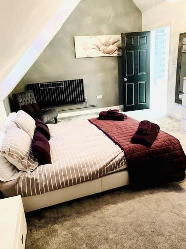 a bedroom with a large bed in a room at The Lodge Annex - immaculate coastal property in Oystermouth