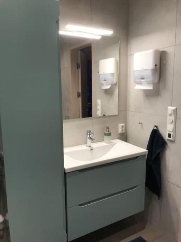 a bathroom with a sink and a mirror at Senjavista, near nature, sea and mighty mountains in Skaland