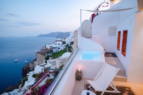 a balcony with a view of the ocean at Oia Mare Villas in Oia