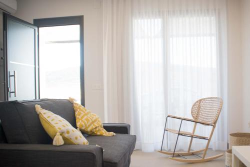 a living room with a couch and a chair at Apartamentos MadreSelva in Fernán Pérez