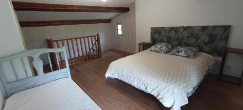 a bedroom with two beds and a staircase at Cabanon L'Olivier in Valensole