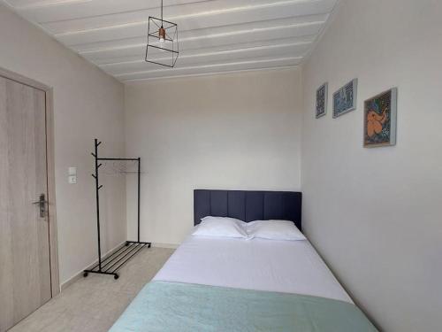 a bedroom with a large bed in a white room at Giannata House in Argostoli