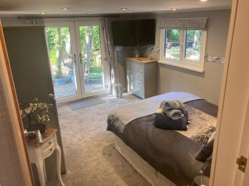 a bedroom with a bed with a stuffed elephant on it at The Spinney lodge in Bubbenhall