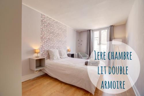 a white bedroom with a large bed and a window at « Le Bidule », logement au cœur de la Champagne in Chouilly