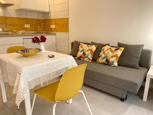 a living room with a table and a couch at Apartamentos MadreSelva in Fernán Pérez