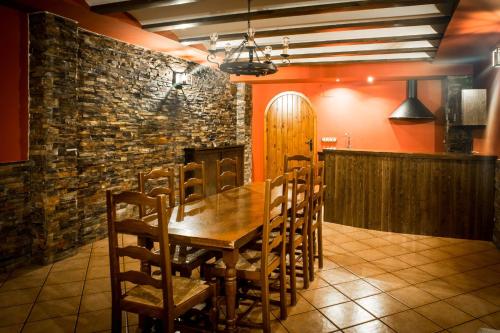 a dining room with a wooden table and chairs at Ciudad de Teruel in Teruel