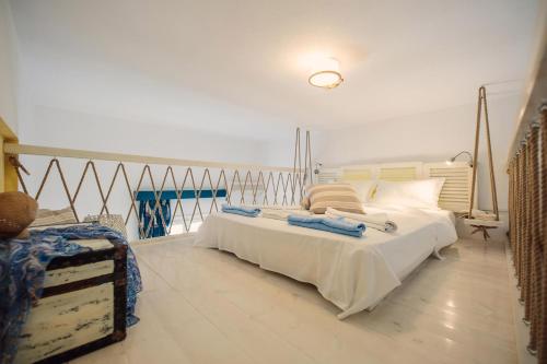 a bedroom with a large white bed in a room at Villa Anna Maria in Aliki