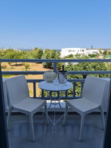 two chairs and a table on a balcony at Zoumis Residence in Naousa