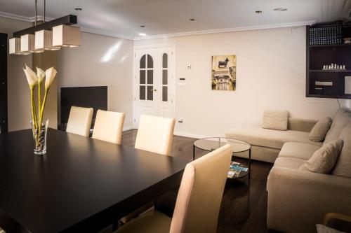 a dining room with a black table and chairs at Ciudad de Teruel in Teruel