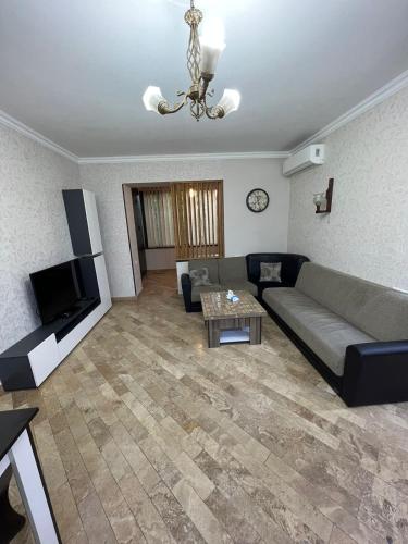 a living room with a couch and a tv at Apartment in Yerevan on Amiryan Street,CENTRE in Yerevan