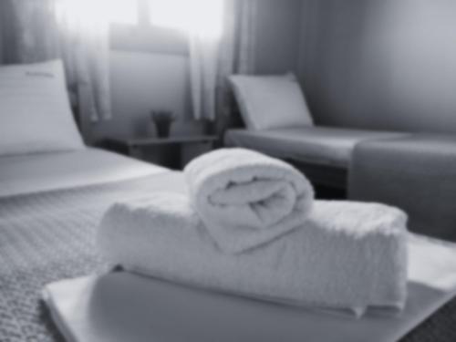 - une chambre d'hôtel avec 2 lits et une serviette dans l'établissement Plakoudis Rooms, à Stavros