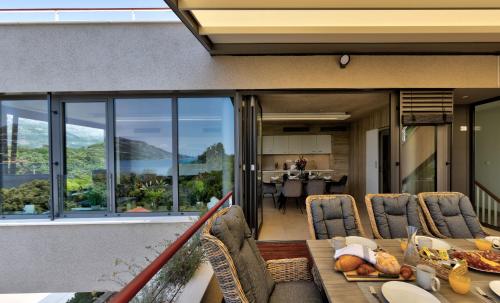 a balcony with a table and chairs and a dining room at Villa Soul Sisters in Korčula