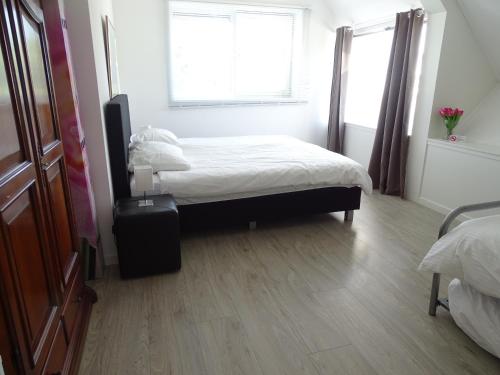 a bedroom with a bed and a window at Guesthouse Wormer in Wormer