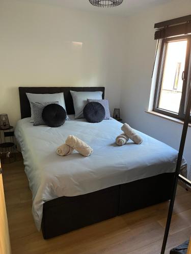 a large bed with two slippers on top of it at Chalet Liquidambar in Zutendaal