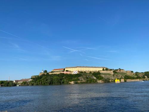a house on an island in the middle of a river at Duga Apartments in Novi Sad