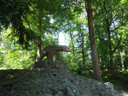 a statue of a bear standing on a pile of rocks at Apartament 221 przy Niedźwiadku in Polanica-Zdrój