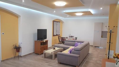 a living room with a couch and a tv at APARTMAN ROSEMARY in Rijeka