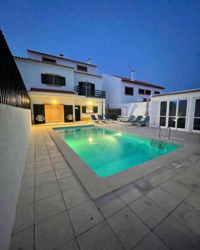 a swimming pool in front of a house at MHouse lease Comporta Centro Villa 3 quartos in Comporta