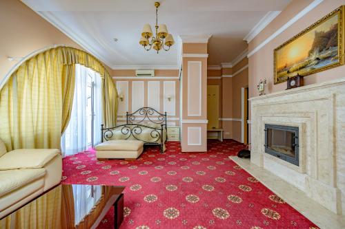 a living room with a fireplace and a couch at Gostiniy Dvor in Odesa