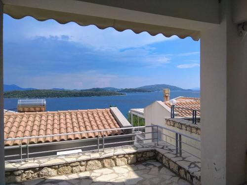 a view of the water from the balcony of a house at Sunrise guest house in Nydri