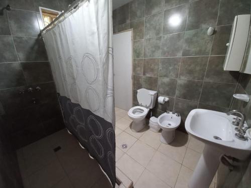 a bathroom with a shower and a toilet and a sink at Quinta La Martita in Ingeniero Giagnoni
