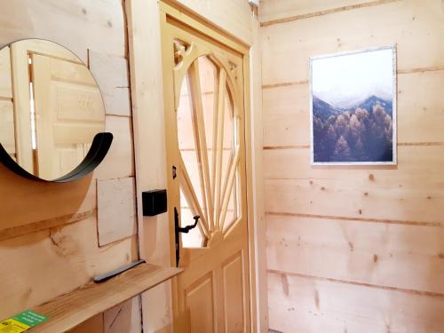 a door to a tiny house with a mirror at Domek Góralski Stary Młyn Zakopane House in Zakopane