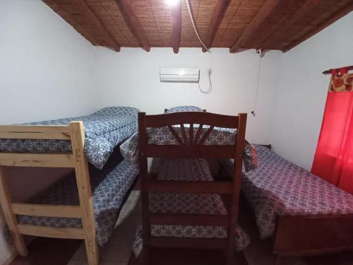 a bedroom with two bunk beds and a ladder at Quinta La Martita in Ingeniero Giagnoni