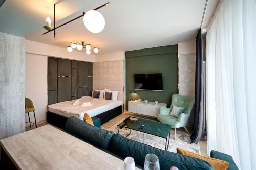 a living room with a bed and a couch at Vogue Sunrise View in Infinity Pool & Spa Resort in Mamaia Sat/Năvodari