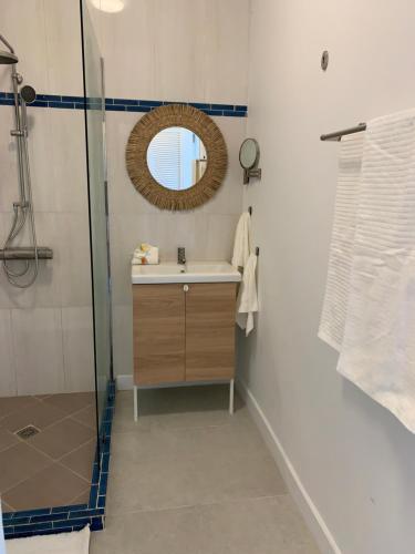 a bathroom with a sink and a mirror at Naturalis - Oceanview Residences in Mahe