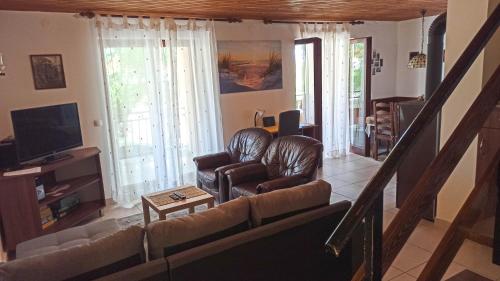 a living room with a couch and a tv at Holiday Home Family - 100m from sea in Vantačići