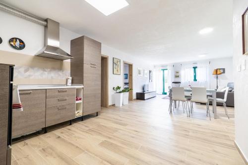 a kitchen and dining room with a table and chairs at Mirni kot in Šmarje