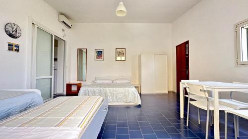 a bedroom with two beds and a desk and a sink at La Chiesura in Galugnano