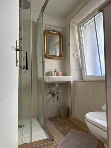 a bathroom with a shower and a sink at CASA 300 in Piran