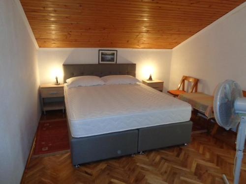 a bedroom with a bed and a desk and a chair at Pansion Danijela in Rogoznica