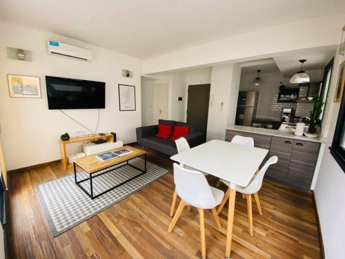 a living room with a table and a couch at Depto de lujo con pileta en San Telmo in Buenos Aires