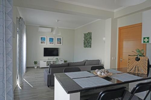 a living room with a couch and a table at Casa Gaio's in Parchal