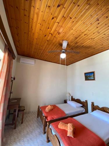 a bedroom with two beds and a ceiling at Emilios see view Apartment in Barbati
