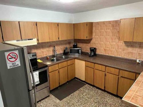 a small kitchen with a sink and a refrigerator at Villa Orquidea 1 in Humacao