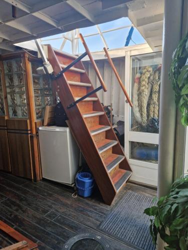 a set of wooden stairs in a room at Ship Windö in Södertälje